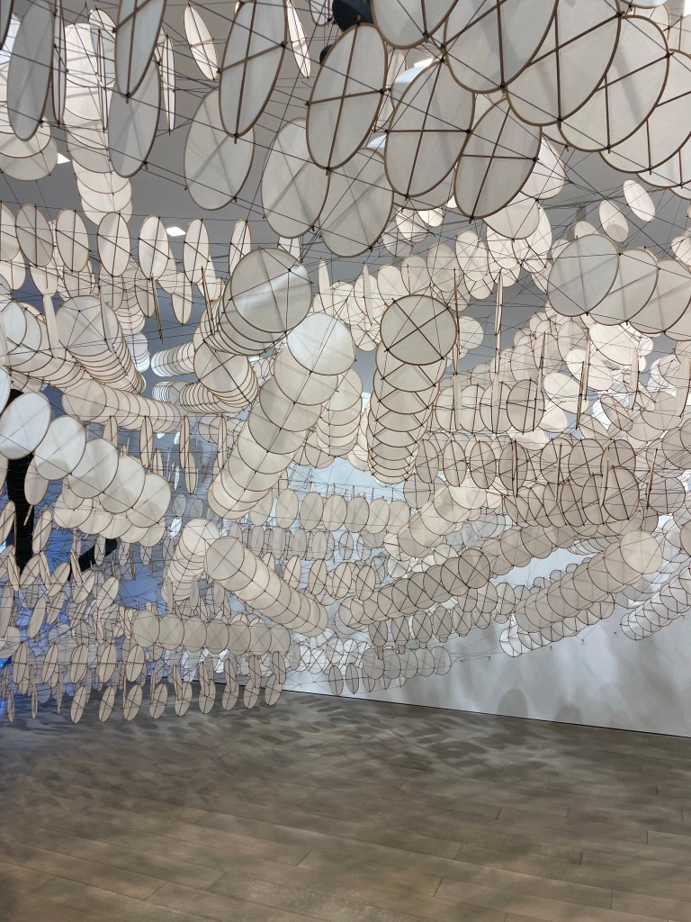 Design and Style Report image< The Disappointment Engine exhibit acrylic and bamboo hanging circles